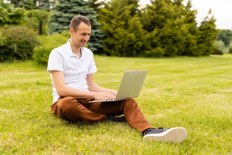 Man working on his laptop in the park, Man working on his laptop in the model released