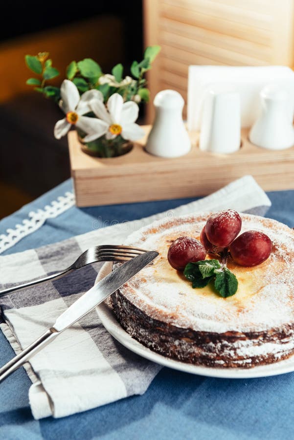 Fresh Creamy traditional cheesecake with grapes and sprinkled wi, Fresh Creamy traditional cheesecake with grapes and sprinkled with powdered sugar.