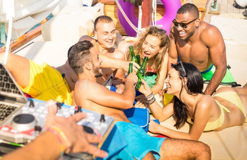 Group of multiracial friends having fun drinking at sail boat party, Group of multiracial friends having fun drinking at sail boat party with dj set - Friendship concept with young multi racial people toasting beer on sailboat