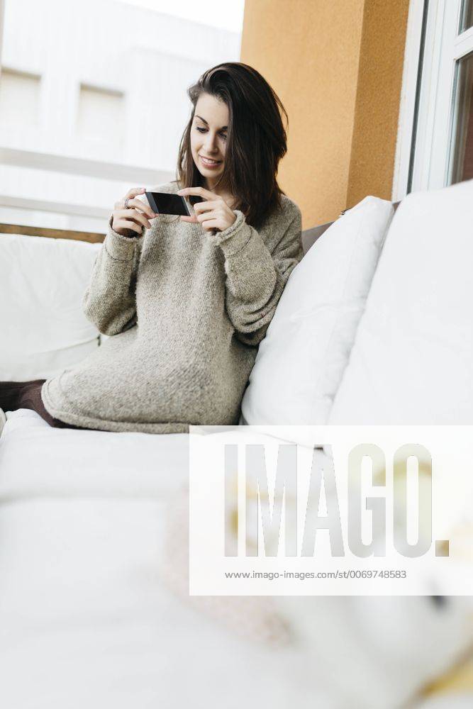 Woman relaxing on balcony model released Symbolfoto property released JRFF000294