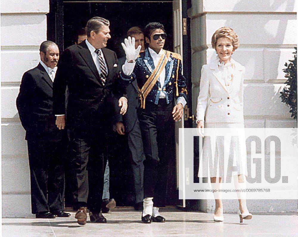 Washington, District of Columbia, United States of America - Pop singer Michael Jackson, center, waves as he and United States President Ronald Reagan, left, and first lady Nancy Reagan, right, arrive at the White House ceremony to launch the Campaign against Drunk Driving in Washington, DC on May 14, 1984..Credit: Washington United States of America - ZUMAs152