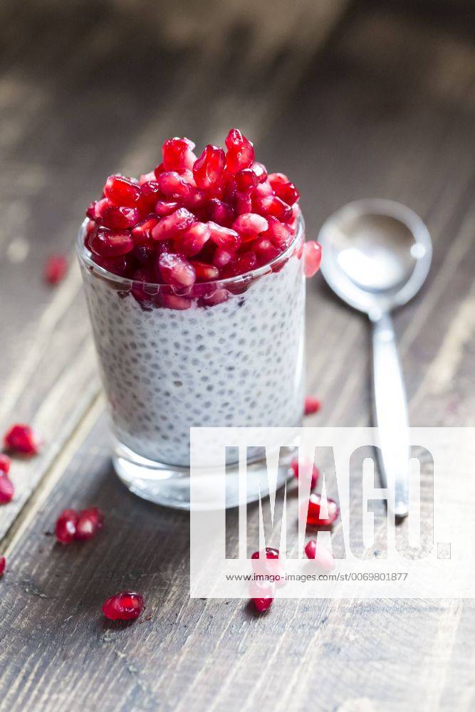 Glass of chia pudding with pomegranate seeds SARF002515