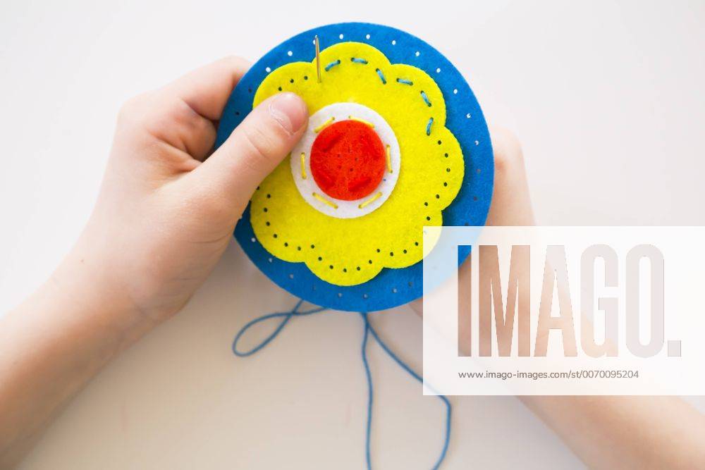 Girl embroidering, felt, decoration model released Symbolfoto LVF004634