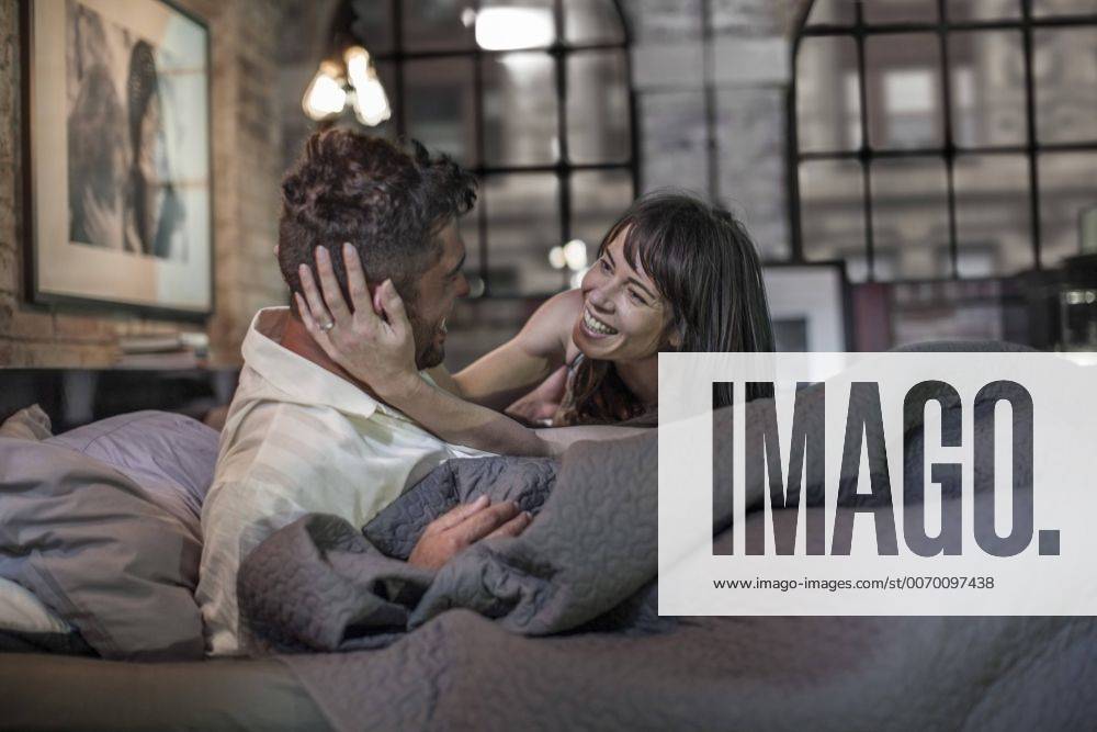 Happy affectionate couple in bed model released Symbolfoto property released ZEF008417