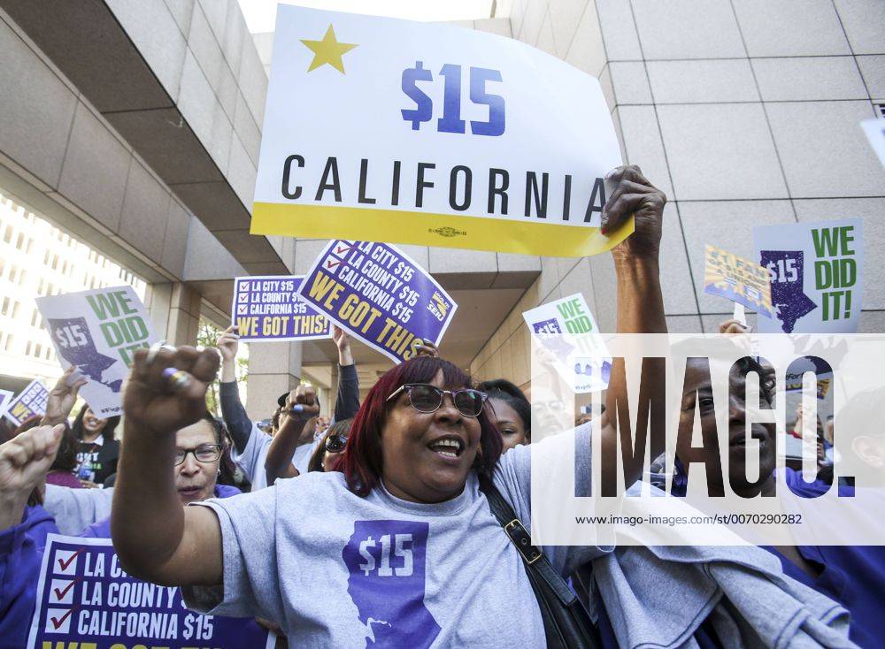 Los Angeles, California, U.S - Supporters of the new minimum wage law celebrate after California Gov. Jerry Brown signed the landmark legislation Monday. California is the first state to commit to raising the minimum wage to $15 an hour by 2022. Los Angeles U.S. - ZUMAc68_