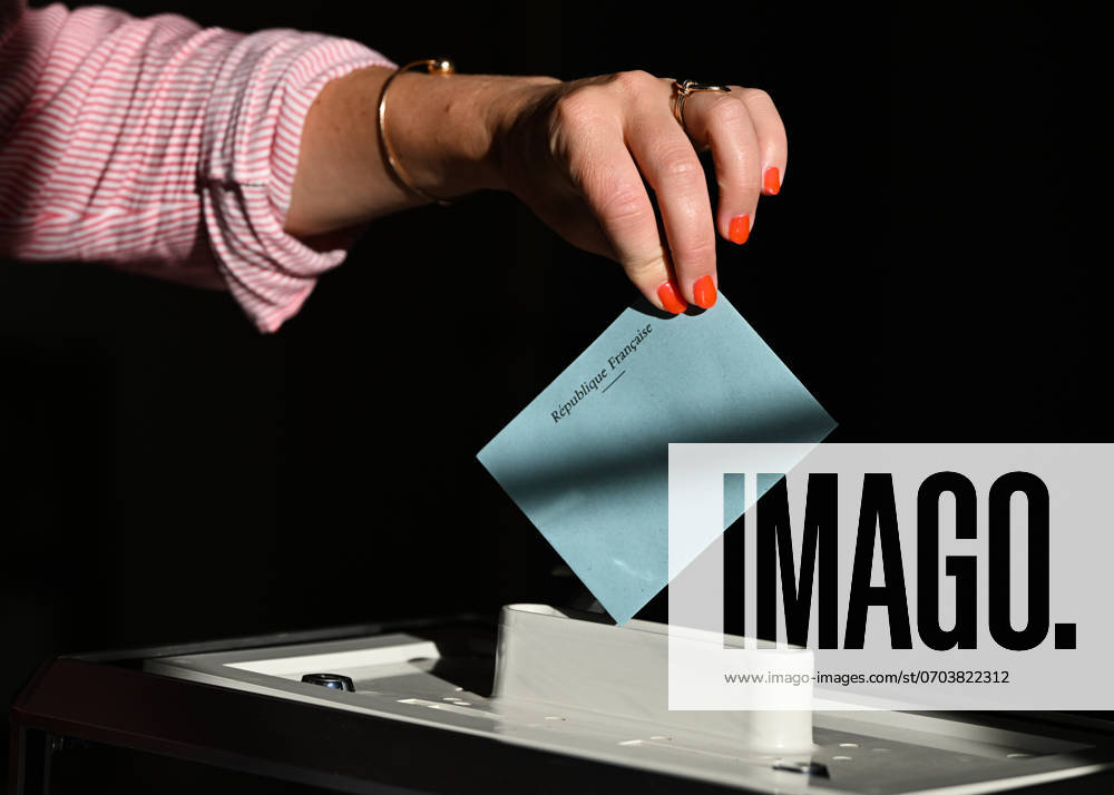 2024 French Legislative Election - Round One SAINT-VAAST-SUR-SEULLES, FRANCE - JUNE 30: A woman casts her vote at Saint-Vaast-sur-Seulles Mairie, a polling station for the 1st constituency of Calvados, during the first round of the 2024 legislative election, on June 30, 2024, in Saint-Vaast-sur-Seulles, Calvados, France. Saint-Vaast-sur-Seulles France
