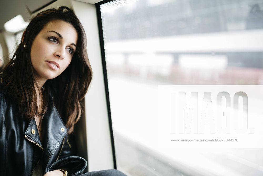 Young woman on train looking out of window model released Symbolfoto JRFF000629
