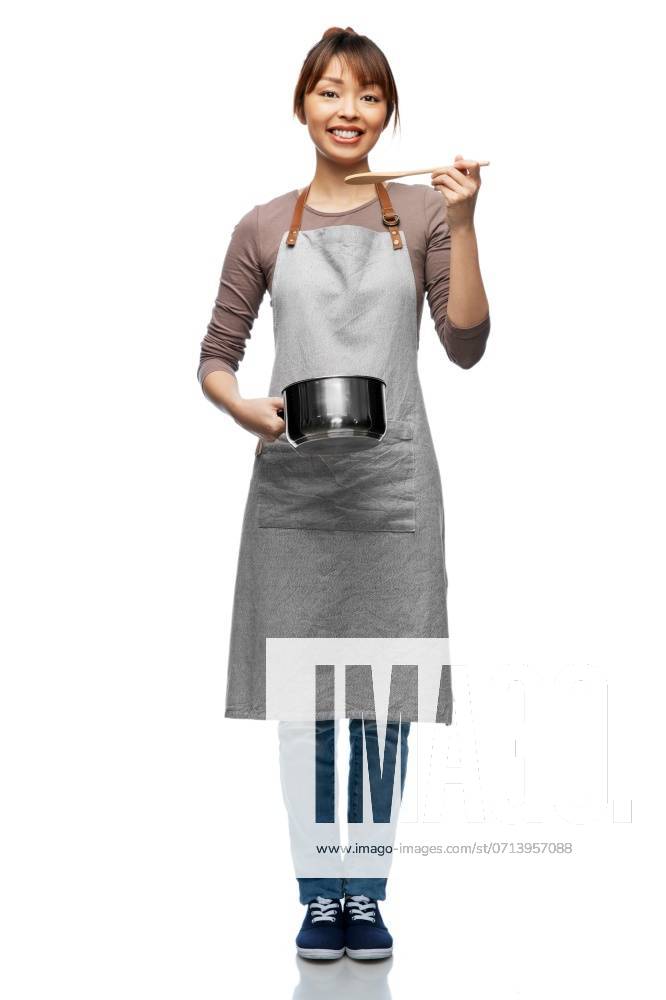 Culinary and people concept - happy smiling female chef in jacket with saucepan cooking food over grey background. happy smiling female chef with saucepan ,model released, Symbolfoto