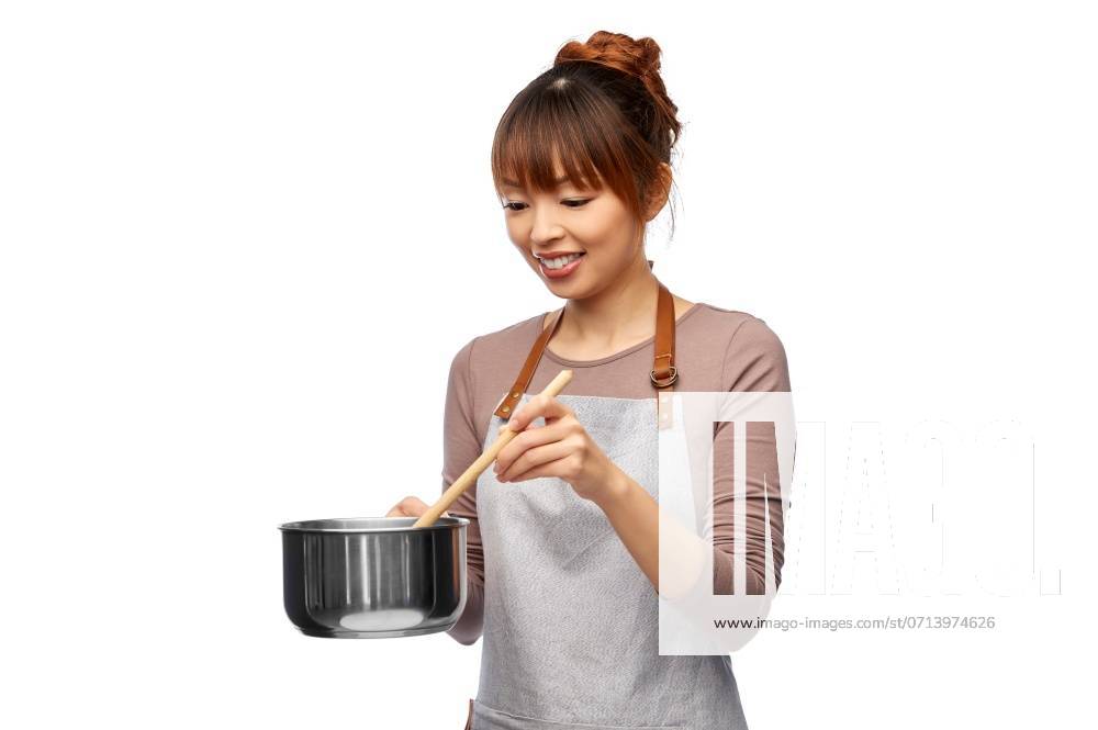 Culinary and people concept - happy smiling female chef in jacket with saucepan cooking food over white background. happy smiling female chef with saucepan ,model released, Symbolfoto