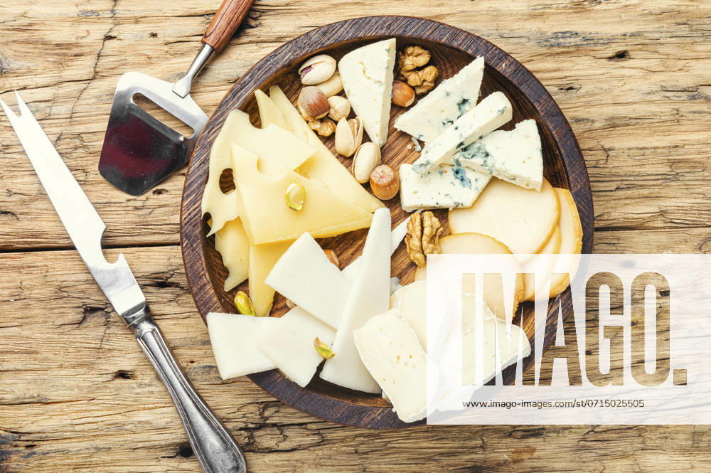 Cheese on the table.various types of cheese on old rustic wooden table. Set of sliced cheeses ,model released, Symbolfoto