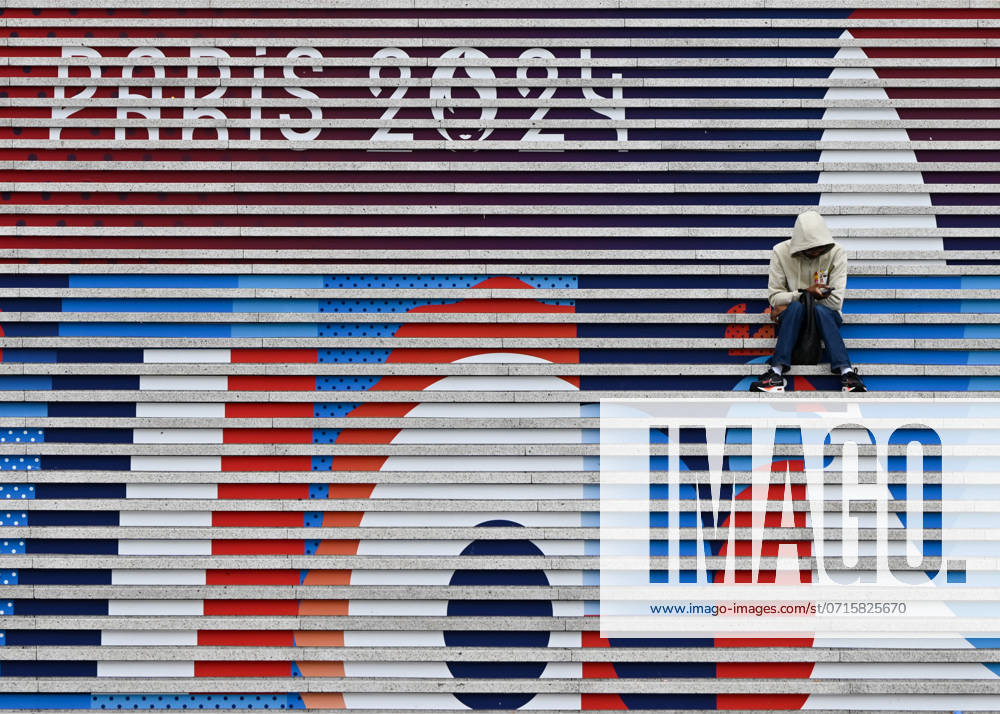 Daily Life In Paris On The Eve Of The Olympics PARIS, FRANCE - JULY 13: A person sits on the steps of the Grande Arche adorned with Olympic-themed paintings, celebrating the upcoming Paris 2024 Olympic and Paralympic Games, on July 13, 2024, in the La DÃ fense district of Paris, France. Paris France
