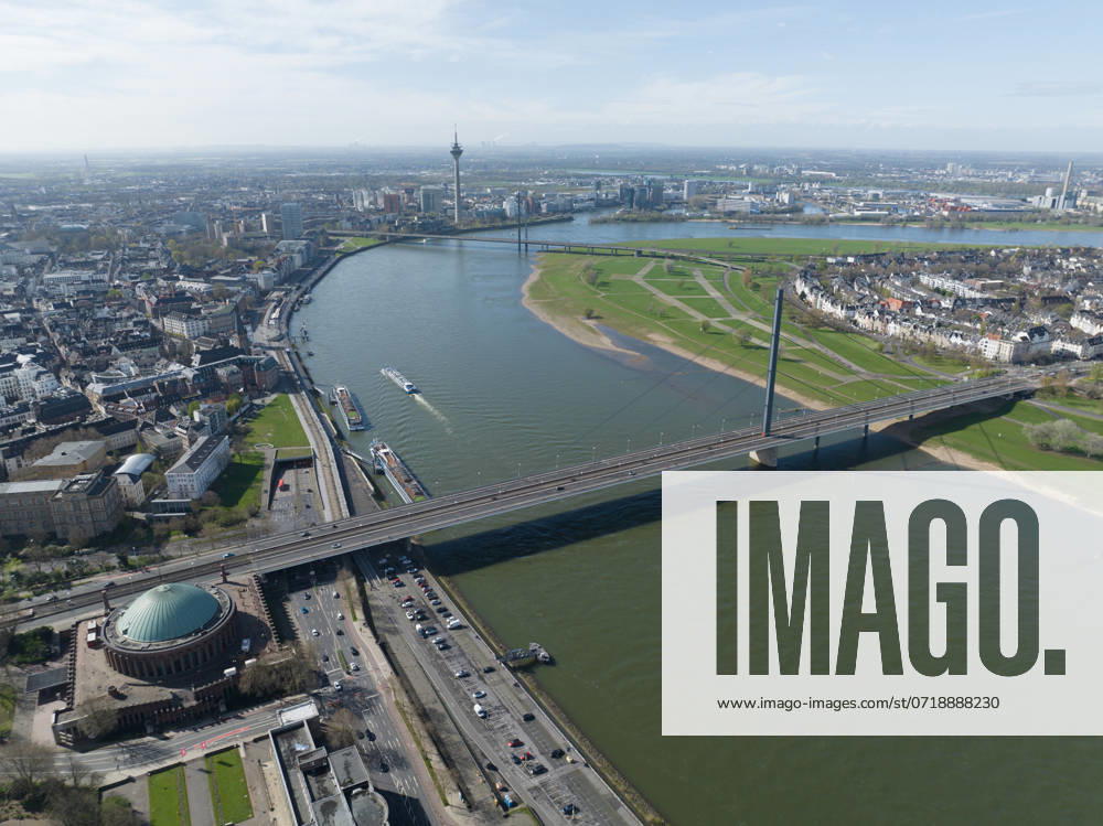Aerial drone view over Dusseldorf, including the Rhine River and the Oberkasseler Brucke, capturing their scenic and architectural features. Aerial photo. Aerial drone view over Dusseldorf, including the Rhine River and the Oberkasseler Brucke, capturing their scenic and architectural features.