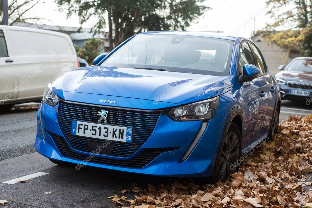 Mulhouse - France - 17 November 2020 - Front view of blue electric Peugeot 208 parked in the street