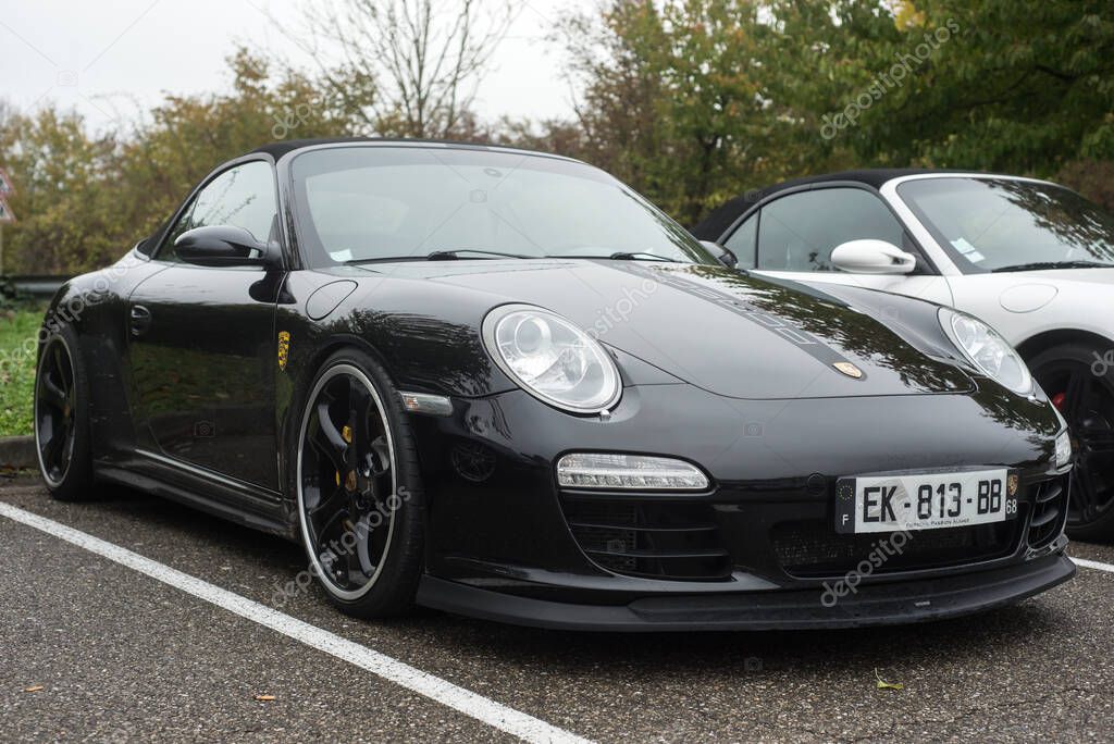 Mulhouse - France - 13 November 2022 - Front view of black Porsche 911 turbo parked in the street