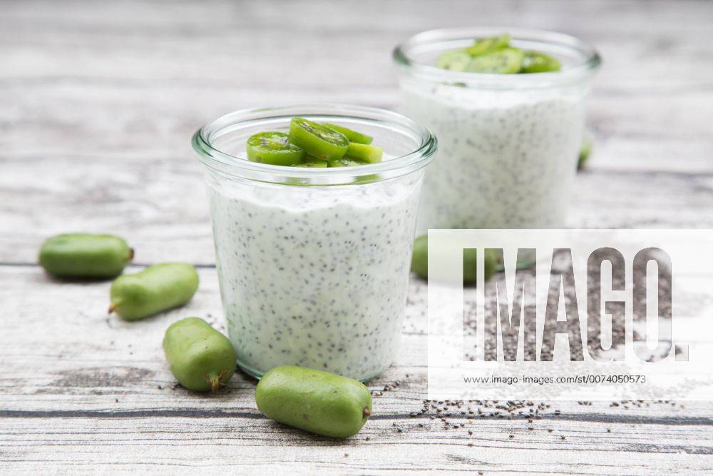 Two glasses of natural yoghurt with chia seeds and slices of hardy kiwis LVF05461