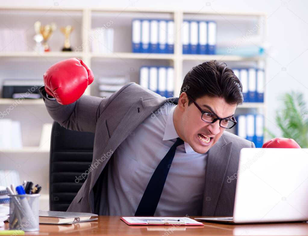 The angry aggressive businessman with boxing gloves