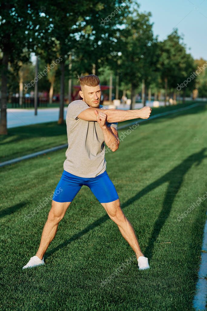Sporty man in the park on the lawn exercise lifestyle. High quality photo
