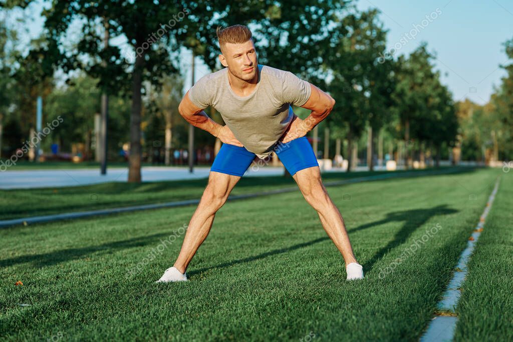Sporty man in the park on the lawn exercise lifestyle. High quality photo