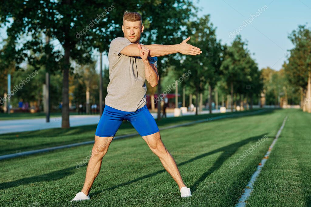 Sporty man in the park on the lawn exercise lifestyle. High quality photo