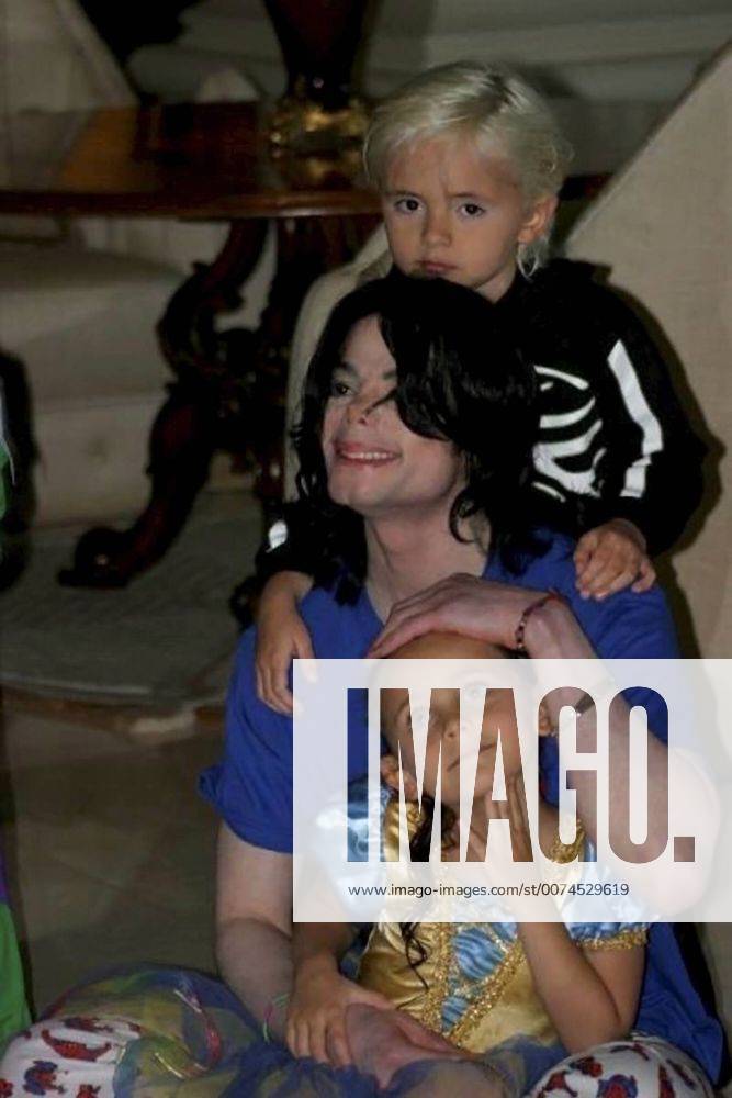 Los Angeles, California, U.S. - (Exact date and location unknown) MICHAEL JACKSON with his son MICHAEL JOSEPH JACKSON, JR. AKA PRINCE MICHAEL, behind, and his daughter PARIS MICHAEL KATHERINE JACKSON on his lap dressed in costumes. - ZUMAz03_ 20090627_zaf_z03_020