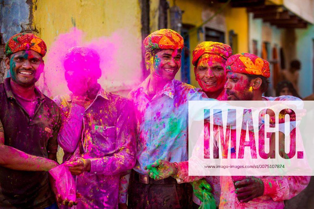 Men throwing colored pigment, Holi Festival, Vrindavan, Uttar Pradesh, India, Asia