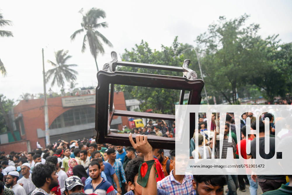 Dhaka celebrate the resignation of the Prime Minister - 05 Aug 2024 A man goes out with a chair from Ganobhaban (the official residence of the Prime Minister of Bangladesh). Thousands of People celebrate the resignation of Bangladeshi Prime Minister Sheikh Hasina. Protests in Bangladesh that began as student-led demonstrations against government hiring rules in July culminated on August 5, in the Prime Minister fleeing and the military announcing it would form an interim government. Dhaka Bangladesh
