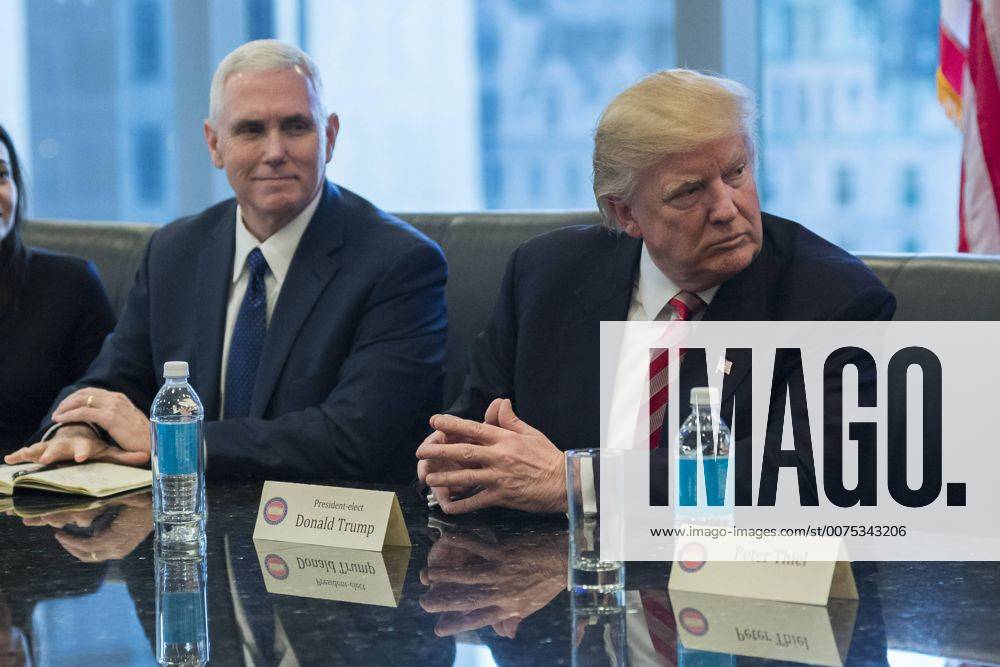 New York, New York, United States of America - United States President-elect Donald Trump (R) and US Vice President-elect Mike Pence (L) are seen at a meeting of technology leaders in the Trump Organization conference room at Trump Tower in New York, NY, USA on December 14, 2016. . New York United States of America - ZUMAs152 20161214_zaa_s152_040
