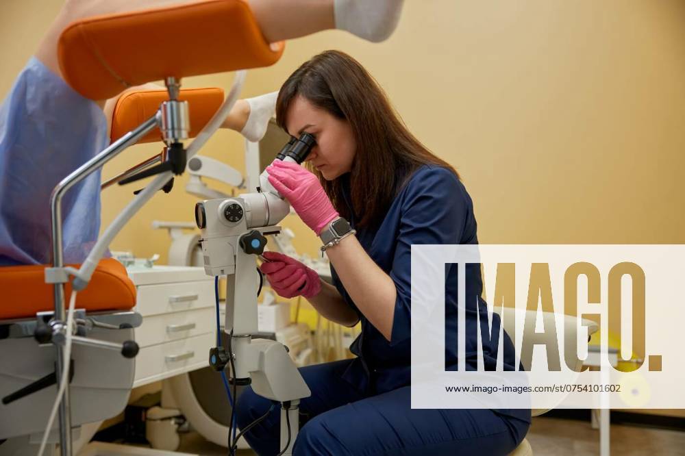 Gynecologist looking in colposcope examining patient on disease, Gynecologist looking in colposcope examining female patient on disease. Colposcopy procedure, cancer diagnostic test, examination of cervix, vagina and vulva of girl in gynecology clinic, Gynecologist looking in colposcope examining female patient on disease. Colposcopy procedure, cancer diagnostic test, examination of cervix, vagina and vulva of girl in gynecology clinic, 15.04.2024,