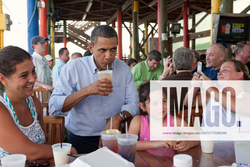Jul. 21, 2010 - Fort Morgan, AL - President Barack Obama sips an iced tea while talking to patrons at Tacky Jack s, a seafood restaurant in Orange Beach, Ala., during his tour of the Gulf Coast, June 14, 2010. This was the President s fourth trip to the Gulf Coast to assess the ongoing response to the BP oil spill in the Gulf of Mexico. Barack Hussein Obama II (born August 4, 1961) is the 44th President of the United States. He is the first African American to be elected to office and the first president born outside the contiguous United States. Born in Honolulu, Hawaii, Obama is a graduate of Columbia University and Harvard Law School. He worked as a civil rights attorney and taught constitutional law at the University of Chicago Law School from 1992 to 2004. While serving three terms representing the 13th District in the Illinois Senate from 1997 to 2004, he ran unsuccessfully in the - ZUMAz03_ 20100721_shh_z03_840