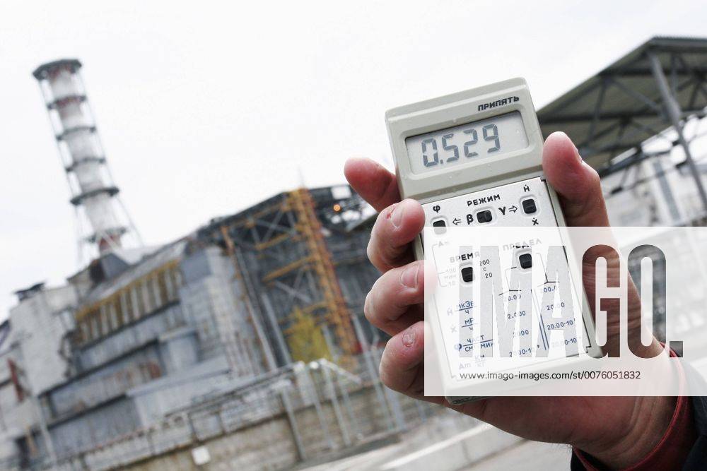 Apr 29, 2007 - Chernobyl, Ukraine - A dosimeter shows the current radiation level outside the Chernobyl Nuclear Power Plant. In the background is Fourth Block of the plant, where the Chernobyl accident occurred on April 26, 1986 during an ill-advised late night safety test. After 21 years, the radiation outside the plant remains high enough that stopping here for more than a brief period is not recommended. Nevertheless, this site is one of many which tourists visit during a one-day excursion into the Exclusion Zone. Chernobyl has become one of Ukraine s hottest tourist destinations. The Exclusion Zone with highest Chernobyl contamination covers 819 square miles. In total, radioactive fallout contaminated 56,700 square miles of Ukraine, Russia and Belarus, a region home to six million people. - ZUMAmr6_ 20070429_rua_mr6_029