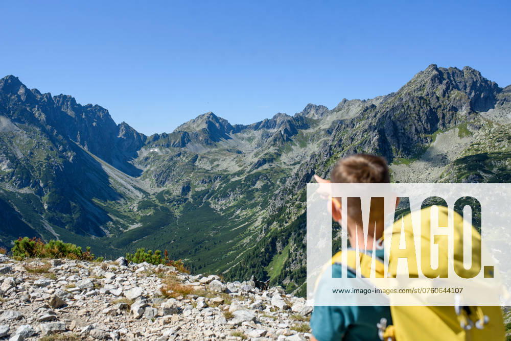 Boy on hike in autumn mountains. Kids spending summer break in nature. Rear view. Boy on hike in autumn mountains. Kids spending time, summer break in nature. Rear view. model released