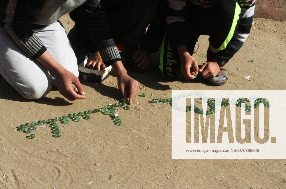 Rafah, Gaza Strip, Palestinian Territory - Palestinian children play marbles in a street in Rafah in the southern Gaza strip on January 19, 2017 Rafah Palestinian Territory - ZUMAap3_ 20170119_zaf_ap3_035