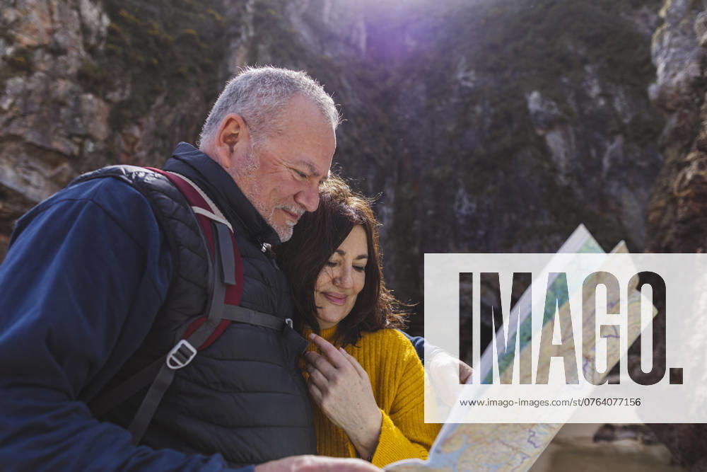 Smiling senior couple searching direction on map with woman at beach model released, Symbolfoto, ALZF00655