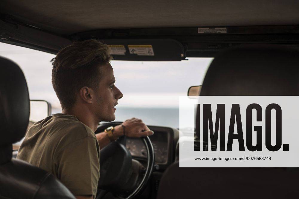 Young man driving car model released Symbolfoto SIPF01246