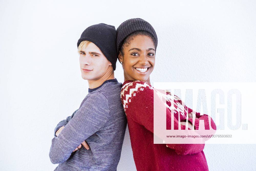 Portrait of young couple back to back in front of white background model released Symbolfoto SIPF01303