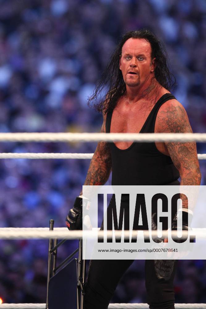 Apr 03, 2011 - Atlanta, Georgia, U.S. - THE UNDERTAKER picks up a chair as the 71,000 supporters cheer him on against Triple H. - ZUMAr72 o0 27, XVII