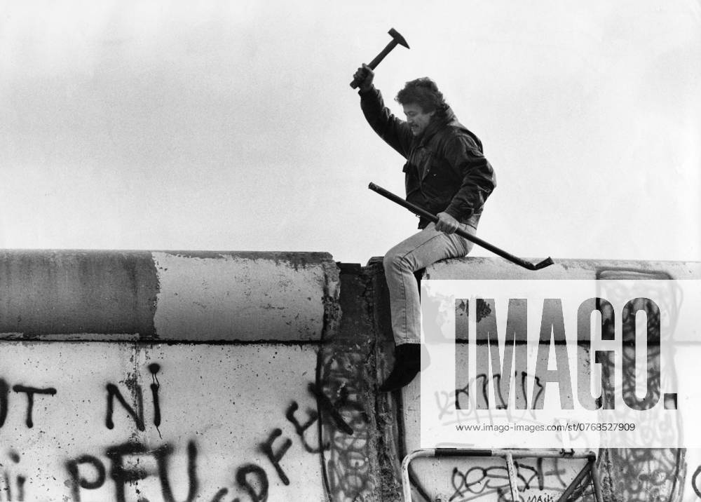 ARCHIVE BERLIN 198911 A man frantically picks at the wall that has divided Berlin into two parts since 1961, in November 1989 the wall fell BERLIN GERMANY