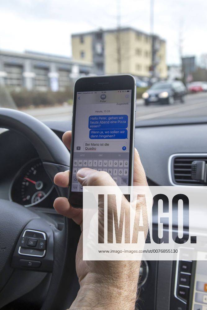 Mann, Autofahrer, benutzt ein Handy, während der Fahrt, SMS schreiben,