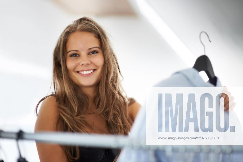 Closet, morning and woman portrait with outfit, modern clothing and confidence at home. Rack, shirt and happy female person with choice and decision in a wardrobe with clothes and style with a smile. model released property released