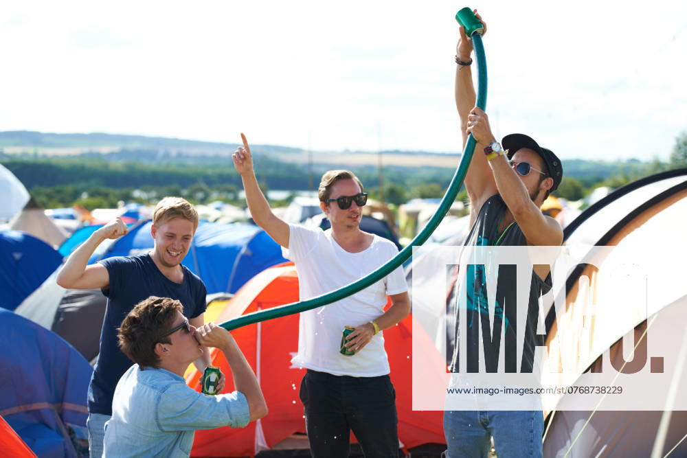 Alcohol, festival or drunk friends drinking together, beer beverage or outdoor social event. Summer music concert, party games celebration or excited people with freedom, hose funnel or pipe tube. model released property released