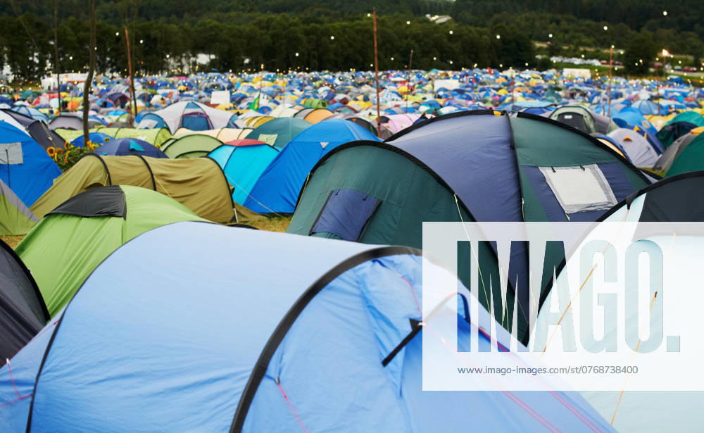 Tent, field and outdoor for festival or camping in nature, summer or forest for adventure or vacation. Event, campsite or setup for sleeping, rest or shelter in woods, trees or environment background. model released property released