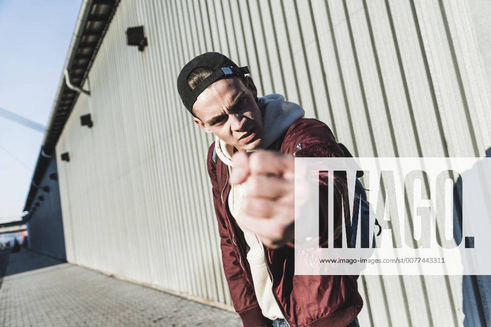 Portrait of aggressive young man making a fist model released Symbolfoto UUF09862