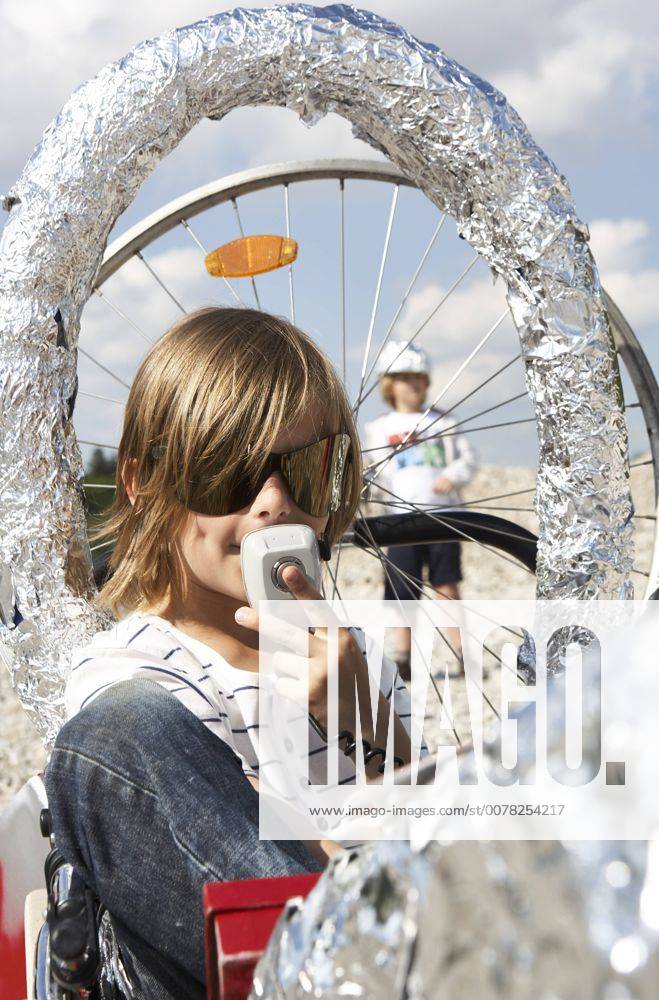 Boy sitting in a self-made rocket playing moon landing model released Symbolfoto FSF00795