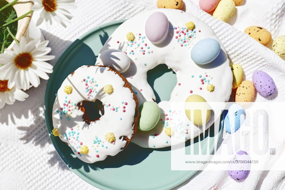 Easter doughnuts decorated with colorful chocolate eggs on table, CATF00555