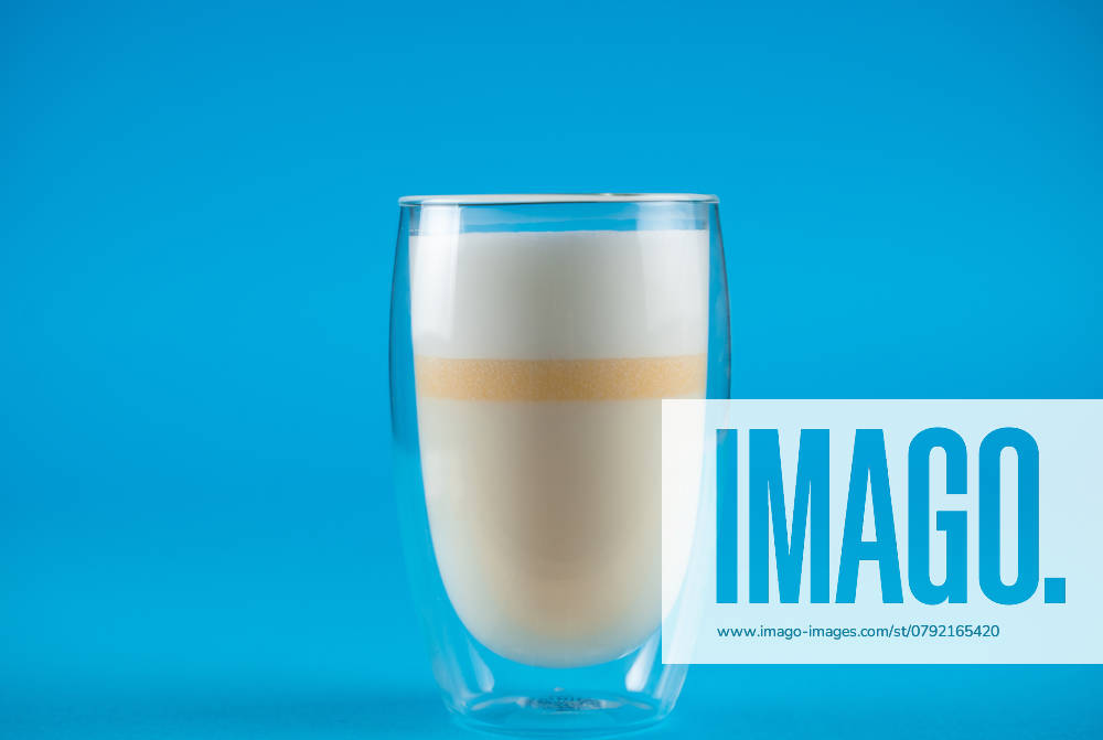 Yellow matcha latte of unripe mangoes on blue background. Matcha cocktail in double glass cup , 45820352.jpg, matcha, drink, milk, glass, yellow, mango, unripe, healthy, beverage, blue, cocktail, pouring, pour, summer, vegetarian, fresh, tasty, vegan, refreshing, mocktail, matcha drink, matcha latte, latte, smoothie, milkshake, white, freshness, foam, lifestyle RECORD DATE NOT STATED