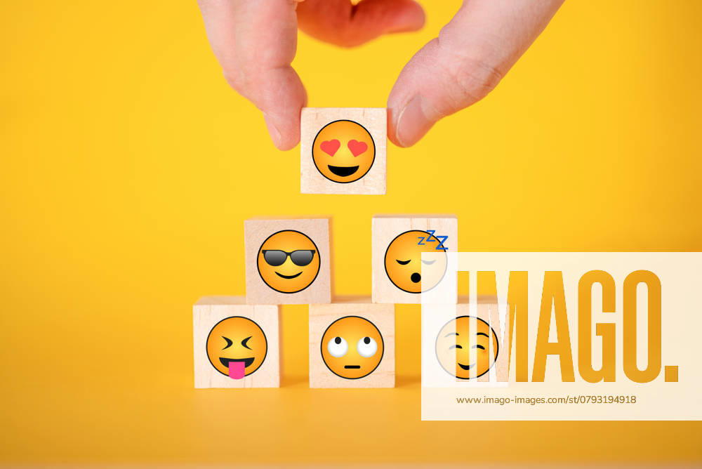 The hand takes a wooden cube with an emoji on a yellow background. The concept of World Emoji Day. , 46955350.jpg, happy, smiley, emoji, face, yellow, positive, wooden cube, hand, concept, good, user, rating, choice, satisfaction, quality, smile, review, opinion, mood, finger, superiority, symbol, poll, sad, unhappy, cube, icon, test, display, customer, modern, button, negative, best, research, excellent RECORD DATE NOT STATED