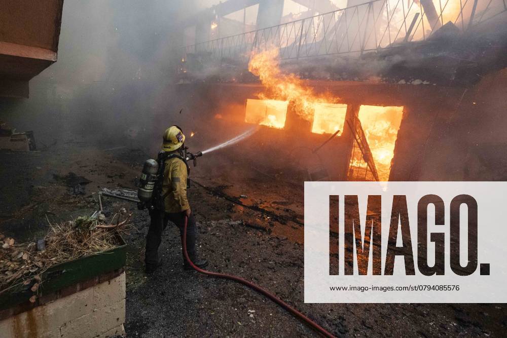 Powerful Winds Fuel Multiple Fires Across Los Angeles Area A LAFD firefighter hoses down the Virginia Pines Apartment building as flames fully consume it due to the Eaton Fire in Altadena, California, on January 8, 2025. Altadena United States