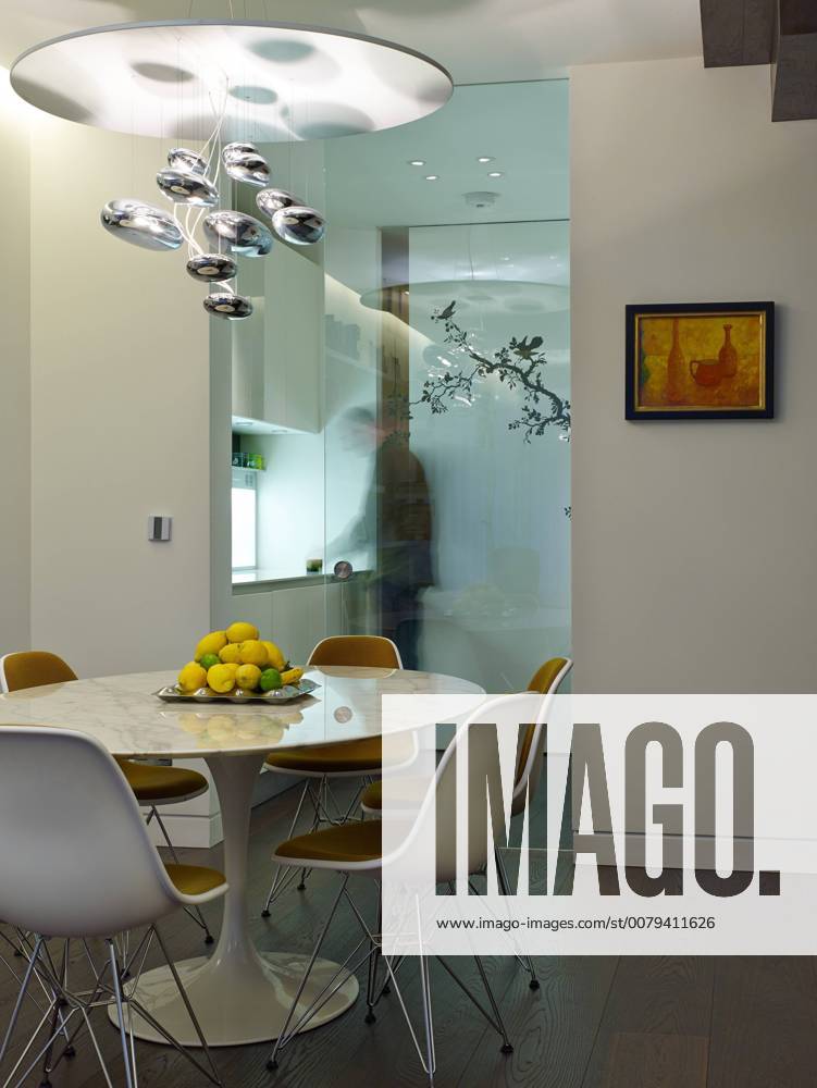 Dining room with glass wall partition in Compass Court Apartment, Shad Thames, London, England, UK United Kingdom