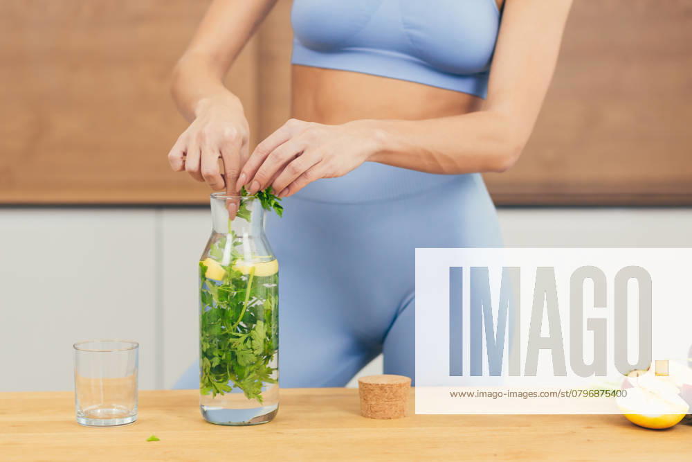 Close up photo, body part of young beautiful fitness woman preparing detox drink with fresh fruits, mint and lemon at home in the kitchen, model released, , 48620130.jpg, close-up, part of, body, portrait, women, lifestyles, preparing, one person, fitness, nutritionist, looking at camera, healthy lifestyle, lemonade, lemon - fruit, mint, juicy, people, healthy eating, adult, detox, one woman only, smoothie, adults only, domestic kitchen, juice - drink, only women, routine, young adult, drinking, vegetable, beautiful woman, color image, dieting, kitchen, morning, beauty, food and drink, ingredient, cooking, fruit, green color, apartment, carefree, enjoyment, exercising, females, slim, smiling, freshness, organic RECORD DATE NOT STATED