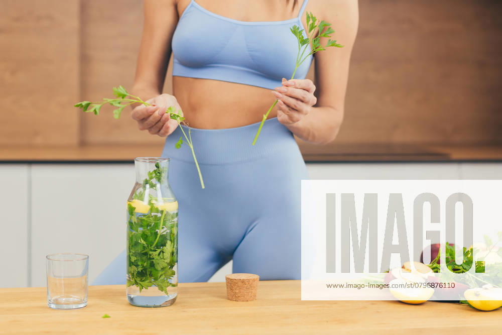 Close up photo, body part of young beautiful fitness woman preparing detox drink with fresh fruits, mint and lemon at home in the kitchen, model released, , 48620336.jpg, close-up, part of, body, portrait, women, lifestyles, preparing, one person, fitness, nutritionist, looking at camera, healthy lifestyle, lemonade, lemon - fruit, mint, juicy, people, healthy eating, adult, detox, one woman only, smoothie, adults only, domestic kitchen, juice - drink, only women, routine, young adult, drinking, vegetable, beautiful woman, color image, dieting, kitchen, morning, beauty, food and drink, ingredient, cooking, fruit, green color, apartment, carefree, enjoyment, exercising, females, slim, smiling, freshness, organic RECORD DATE NOT STATED
